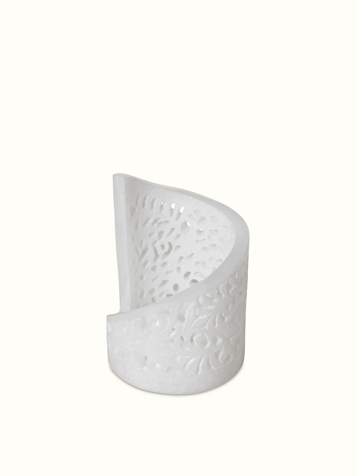 Top view of polished carved soapstone tea light holder, emphasizing the detailed carvings and polished finish.
