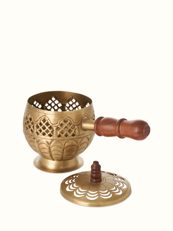 Close-up of Polished Brass Dhuna focusing on its intricate designs and lustrous brass surface.