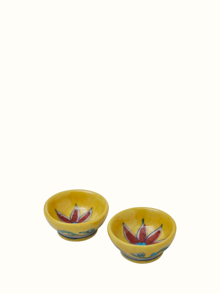 Close-up of polished blue pottery stoneware pooja thali set, focusing on the detailed blue patterns and finishes.