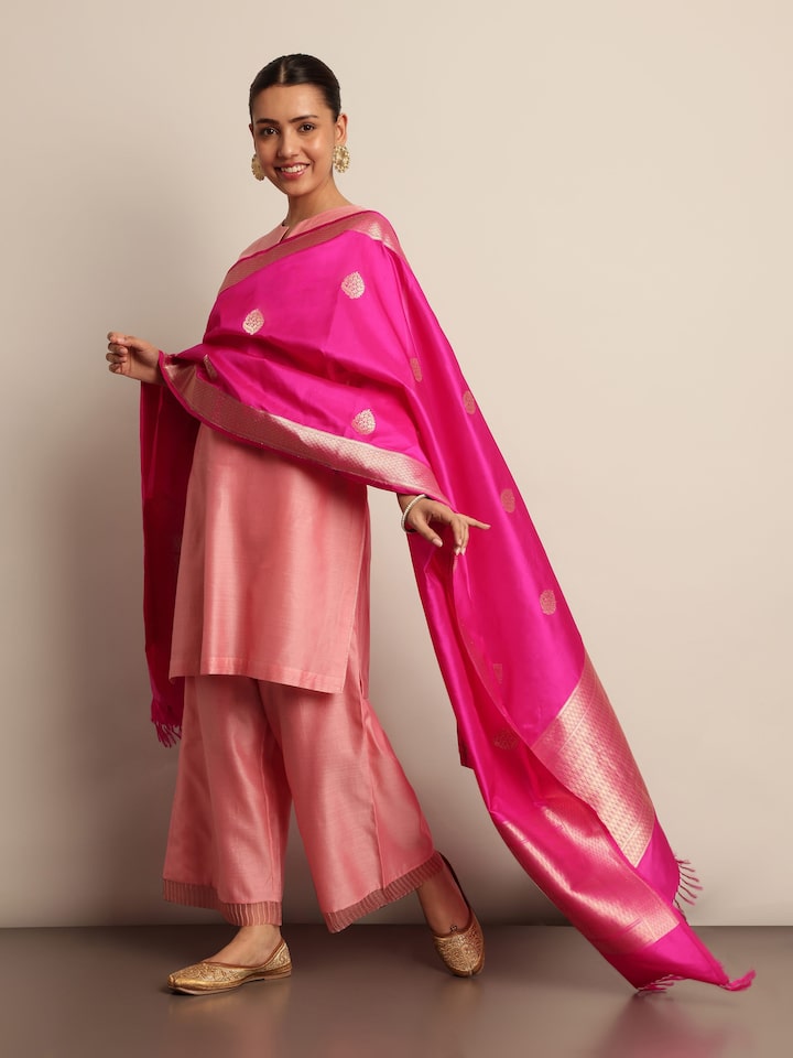 Lifestyle shot of pink silk Banarasi dupatta draped elegantly over shoulder.