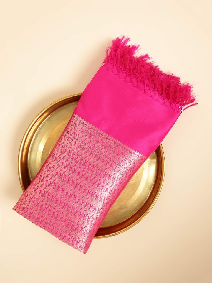 Close-up of pink silk Banarasi dupatta border showcasing intricate zari work.