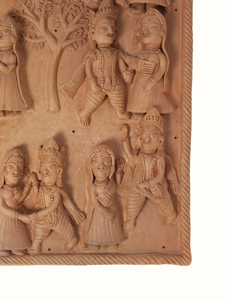 Side view of Terracotta clay Radha Krishna raas leela idol highlighting texture