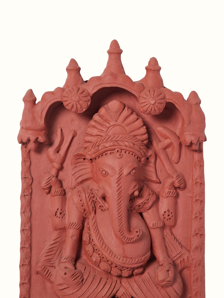 Side view of matte terracotta clay Ganesha idol, showcasing the detailed craftsmanship and artistic design.