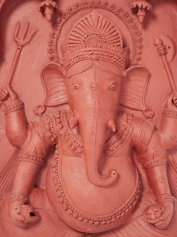 Full view of terracotta clay Ganesha idol, emphasizing its intricate patterns and cultural significance.