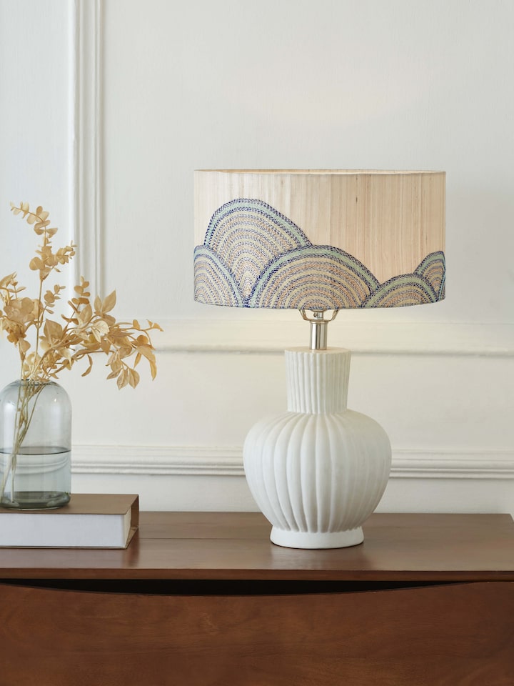 Side view of Sujani hand-embroidered cotton lampshade in beige color showcasing detailed stitching