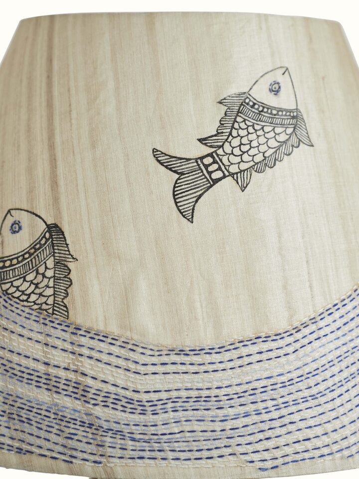 Angled view of Sujani embroidered cotton lampshade in beige color