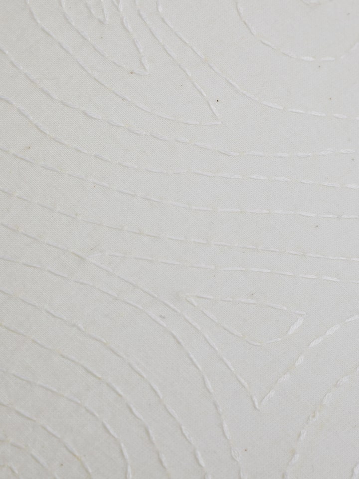 Angled view of Sujani Embroidered Simple Cotton Lampshade, showing the overall shape and design elements