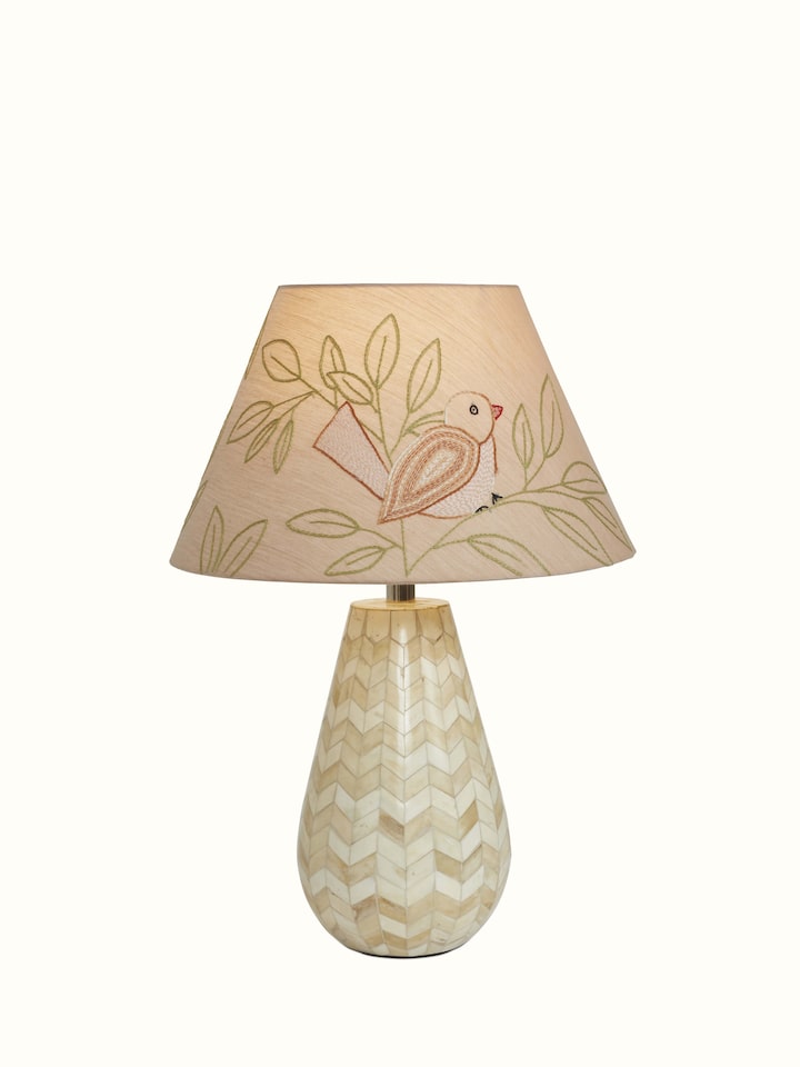 Angled view of Sujani embroidered cotton lampshade in large beige color highlighting the fine stitching and design