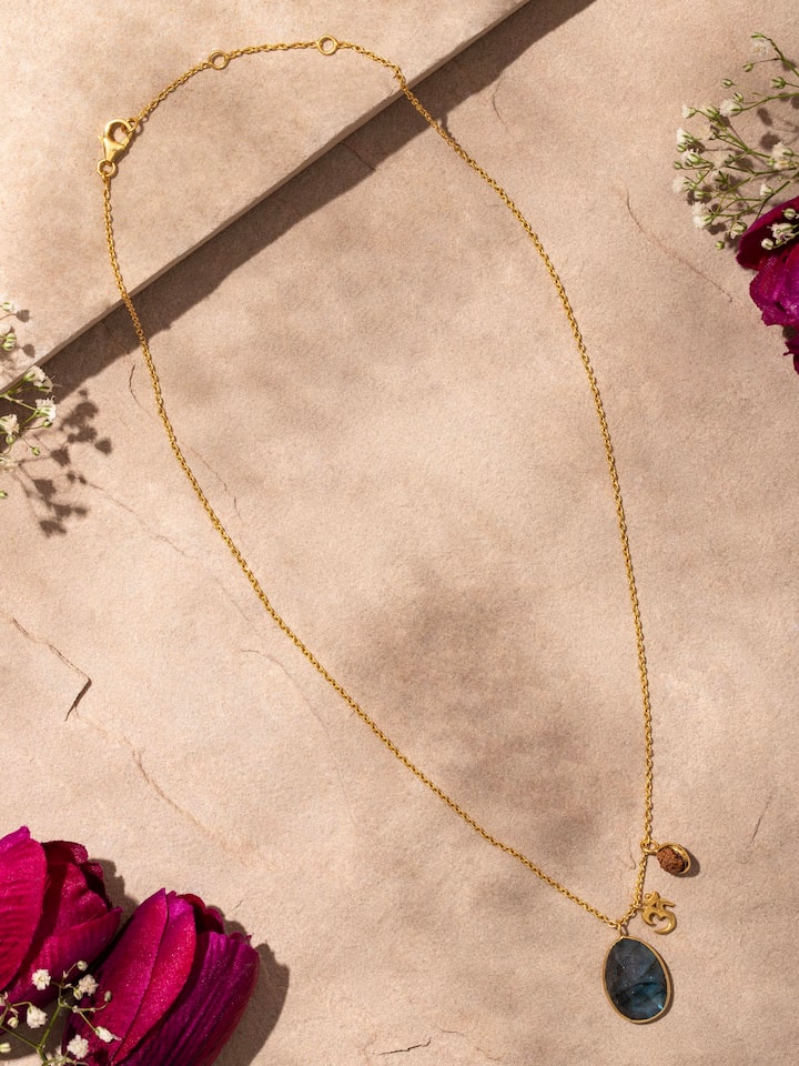 Detailed view of Labradorite, OM silver charm & Rudraksha necklace, highlighting the gold-plated sterling silver design.