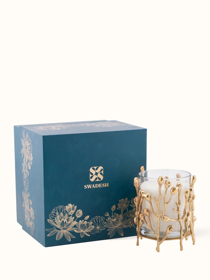 Angled view of Brass Candle (Small) highlighting the candle's form and shine.