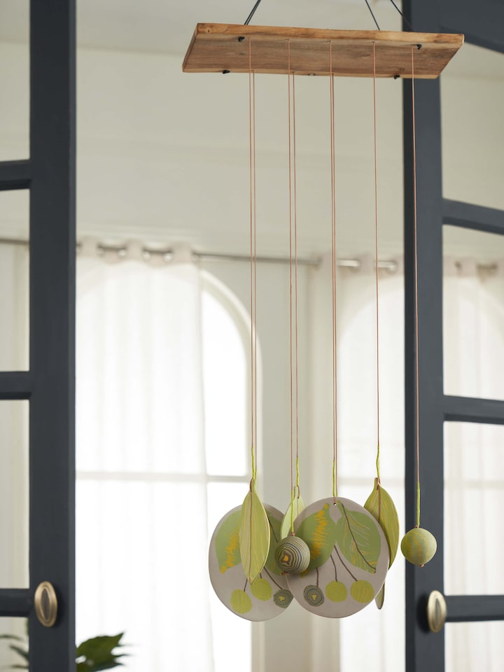 Close-up view of Melodious Ceramicware Clay Wind Chime, focusing on the vibrant colors and ceramic detailing.