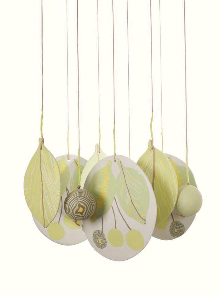 Angled view of Melodious Ceramicware Clay Wind Chime, showcasing its overall structure and hanging elements.