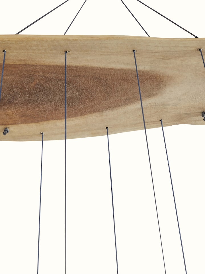 Angled view of Resonant Ceramicware Clay Wind Chime emphasizing its unique texture and color