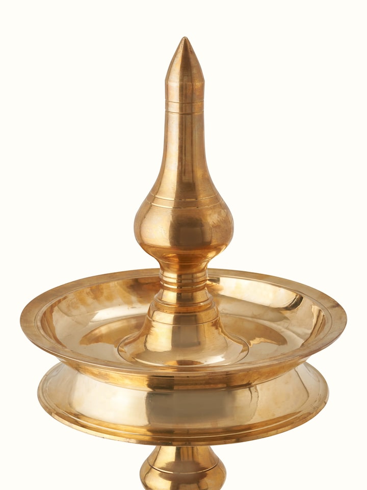 Close-up of Brass-plated Kuthu Vilakku Stand Diya emphasizing the detailed brass work and refined design