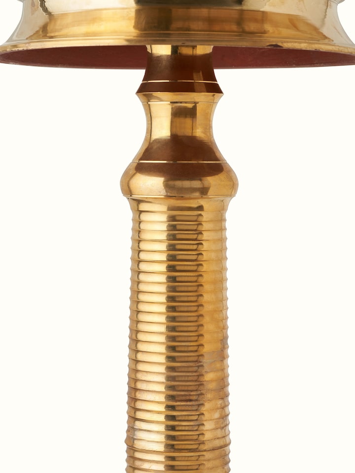 Angled view of Brass-plated Kuthu Vilakku Stand Diya focusing on the beautiful curves and brass detailing of the stand