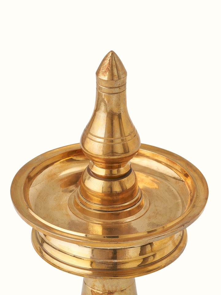 Close-up of Brass-plated Samai Vilakku stand diya showing the refined brass finish and decorative elements