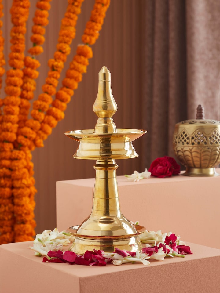 Side view of Kerala brass samai vilakku emphasizing its ornate brasswork and craftsmanship