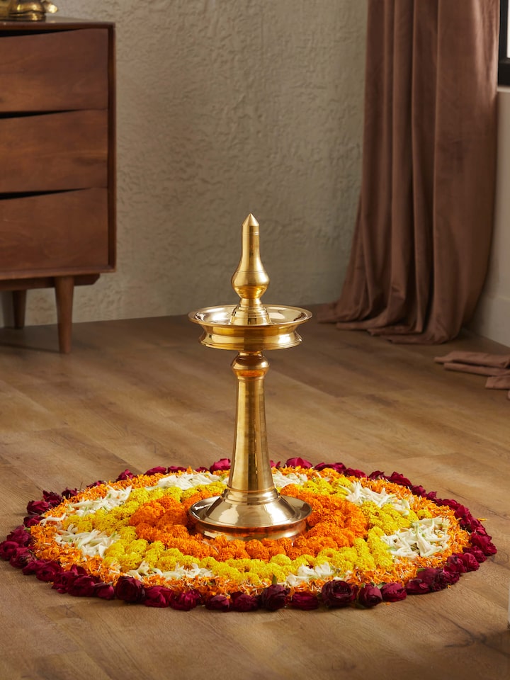 Front view of brass samai vilakku stand diya, highlighting the intricate brass work and traditional style.
