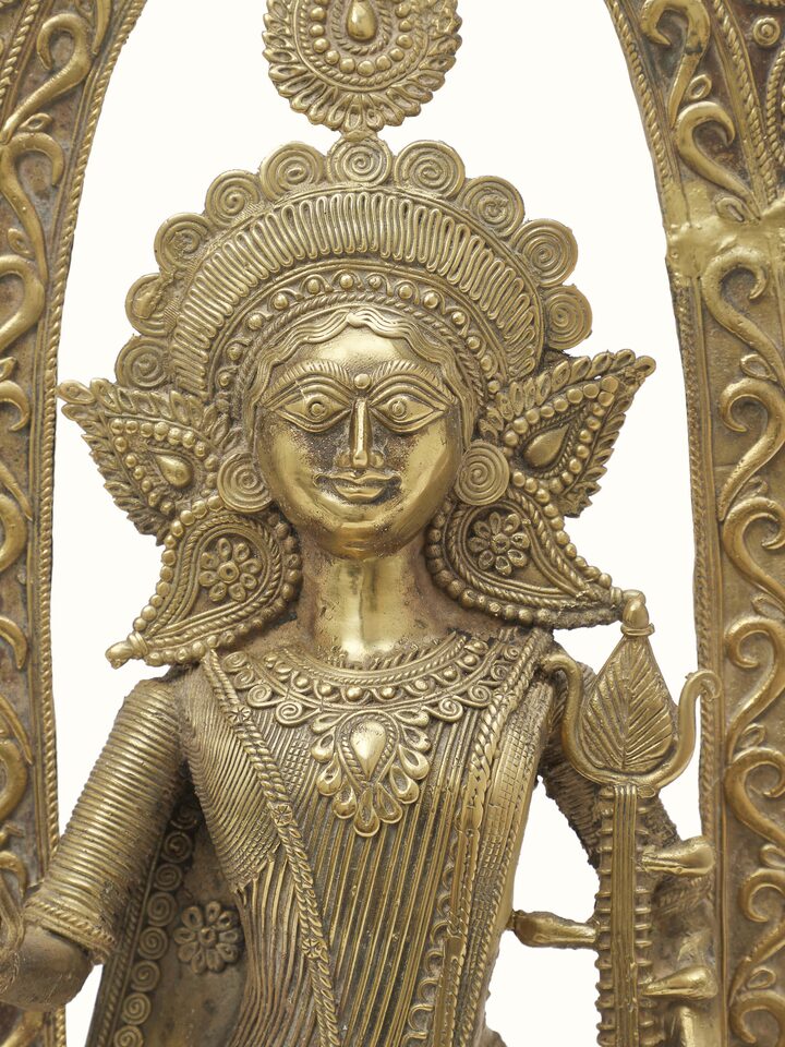 Dhokra Saraswati Brass Idol from an angle emphasizing the detailed sculpture and texture