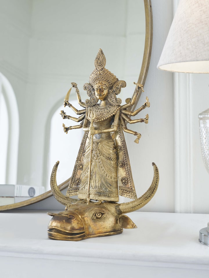 Side view of Brass dhokra Durga on bull idol in golden color highlighting intricate details and elegant finish.