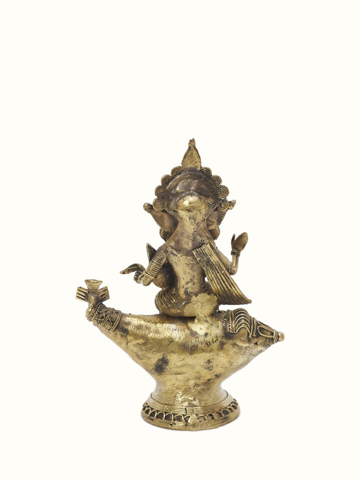 Detailed view of Vishnupatni dhokra brass Lakshmi on conch shell idol with ornate design