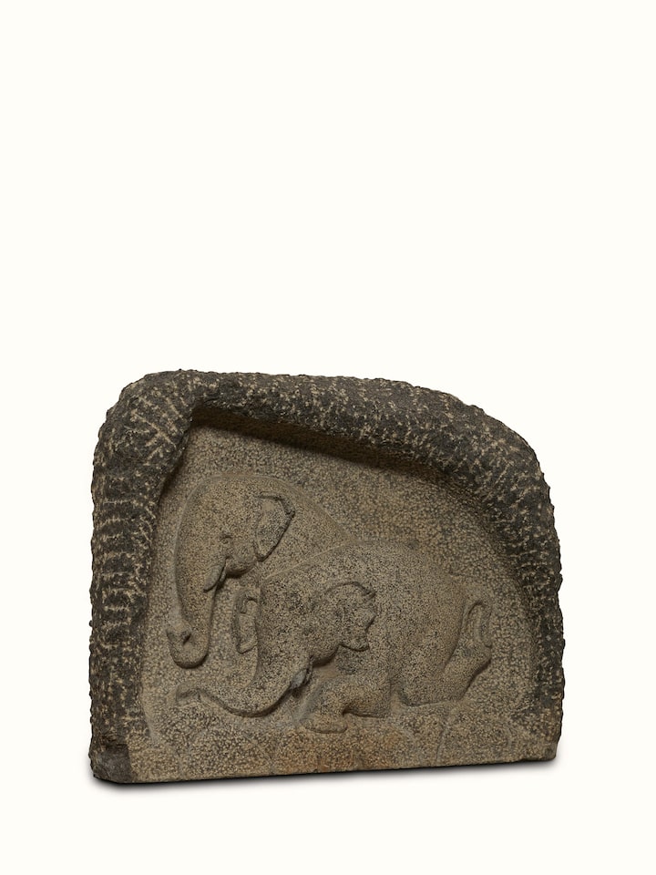Side view of Adambara carved stone shore elephants sculpture emphasizing the craftsmanship and intricate details.