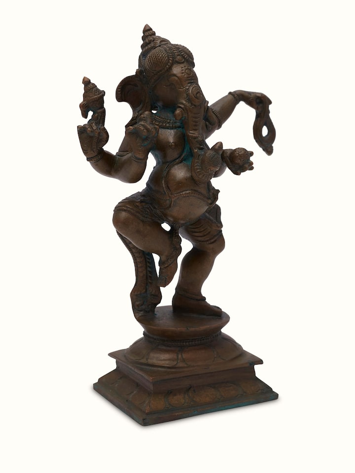 Side view of bronze casting dancing Ganesha idol highlighting the intricate details and bronze finish