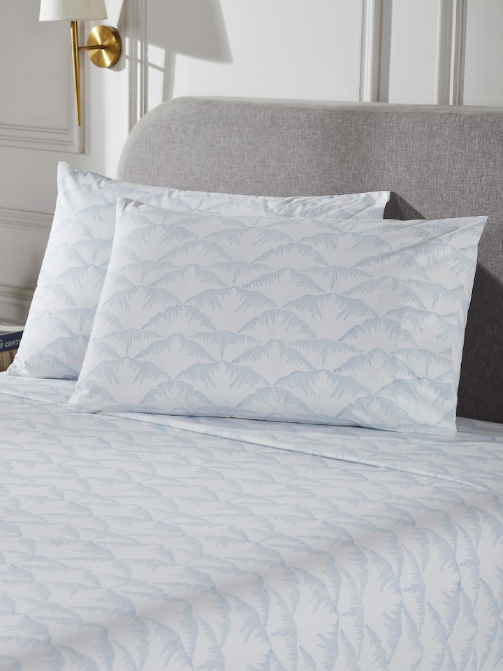 Side view of Parvat blue textured cotton Sanganeri block printed queen bedsheet set focusing on the fabric texture