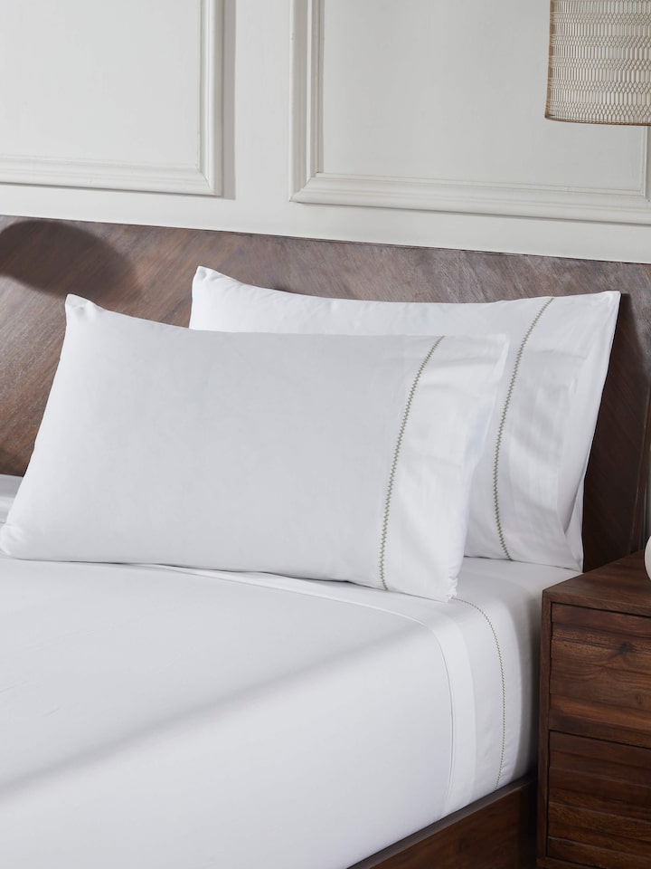Close-up of Parvat beige stripe cotton hand embroidered bedsheet king set focusing on the detailed hand embroidery and stripe pattern.