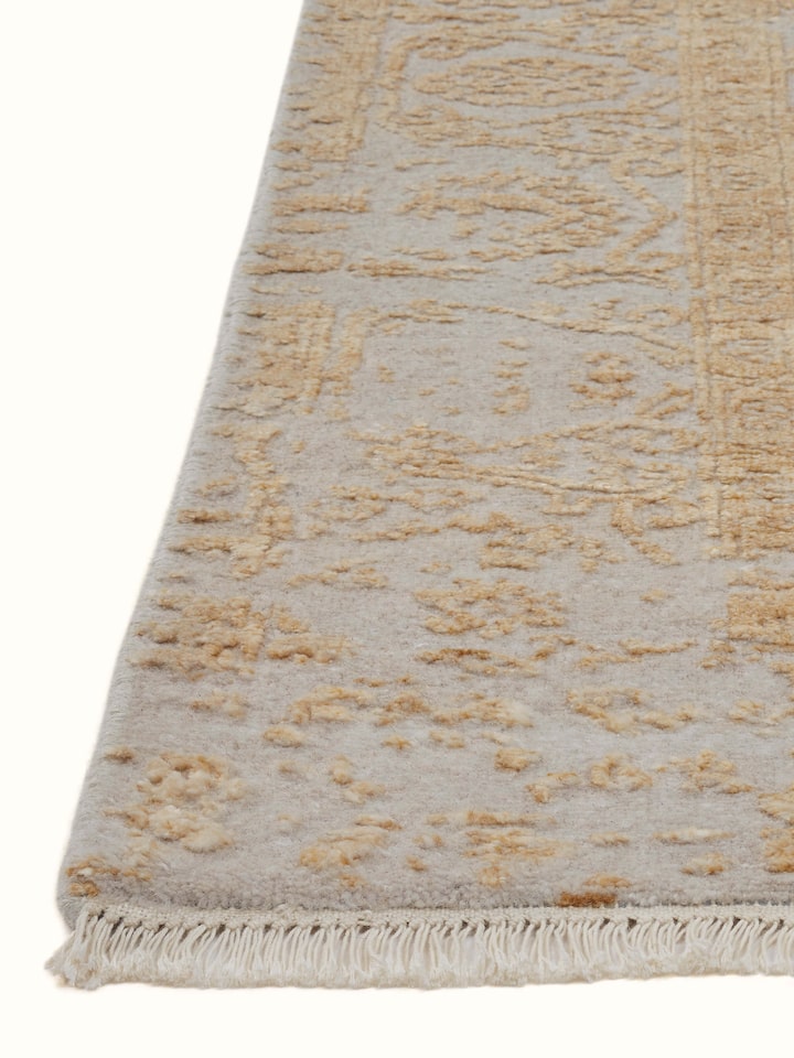 Detailed view of Distressed Transitional Beige Agra Wool & Viscose Hand-Knotted Rug, showing the texture and intricate design.