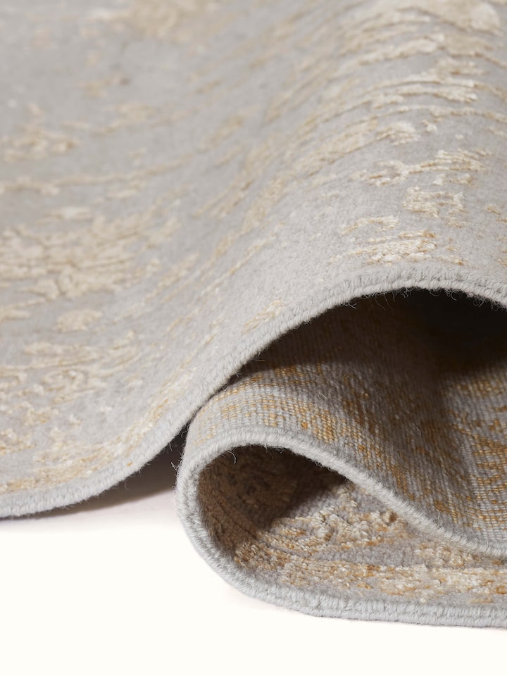 Side view of Distressed Transitional Beige Agra Wool & Viscose Hand-Knotted Rug, emphasizing the thickness and craftsmanship.