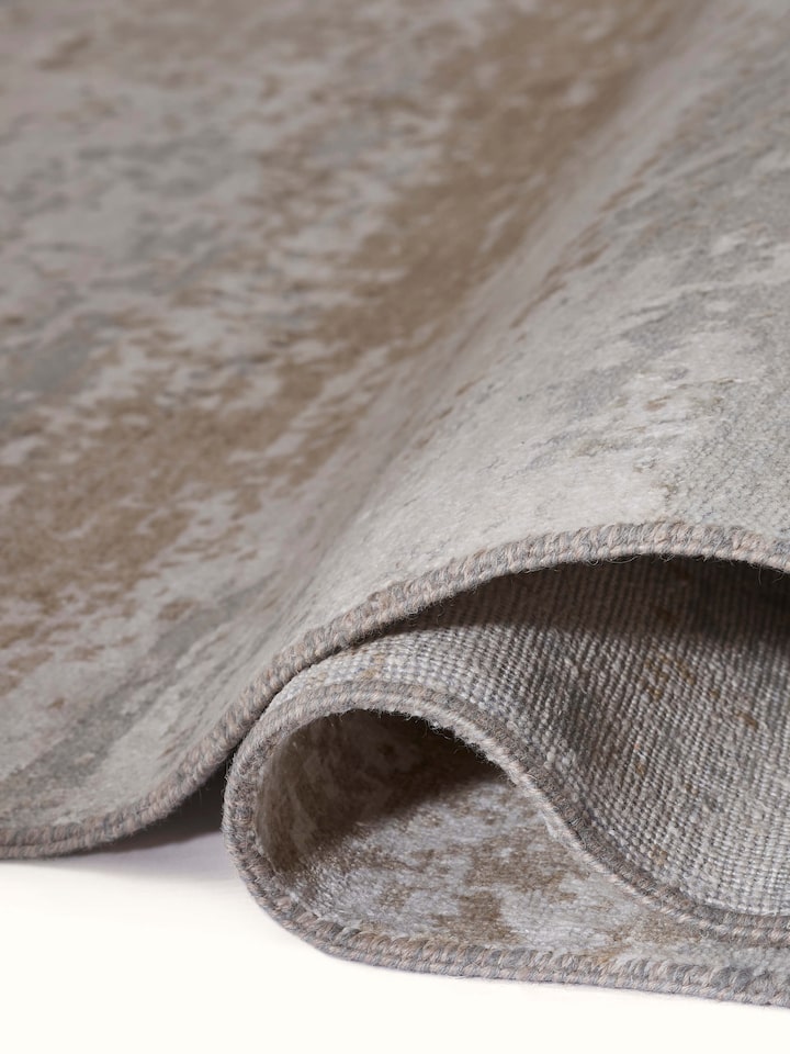 Side detail of modern abstract Agra wool and viscose carpet in taupe and grey tones