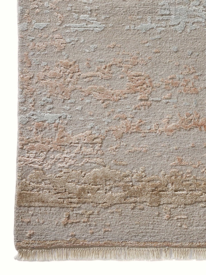 Close-up of abstract beige carpet showcasing hand-knotting detail and wool-viscose texture