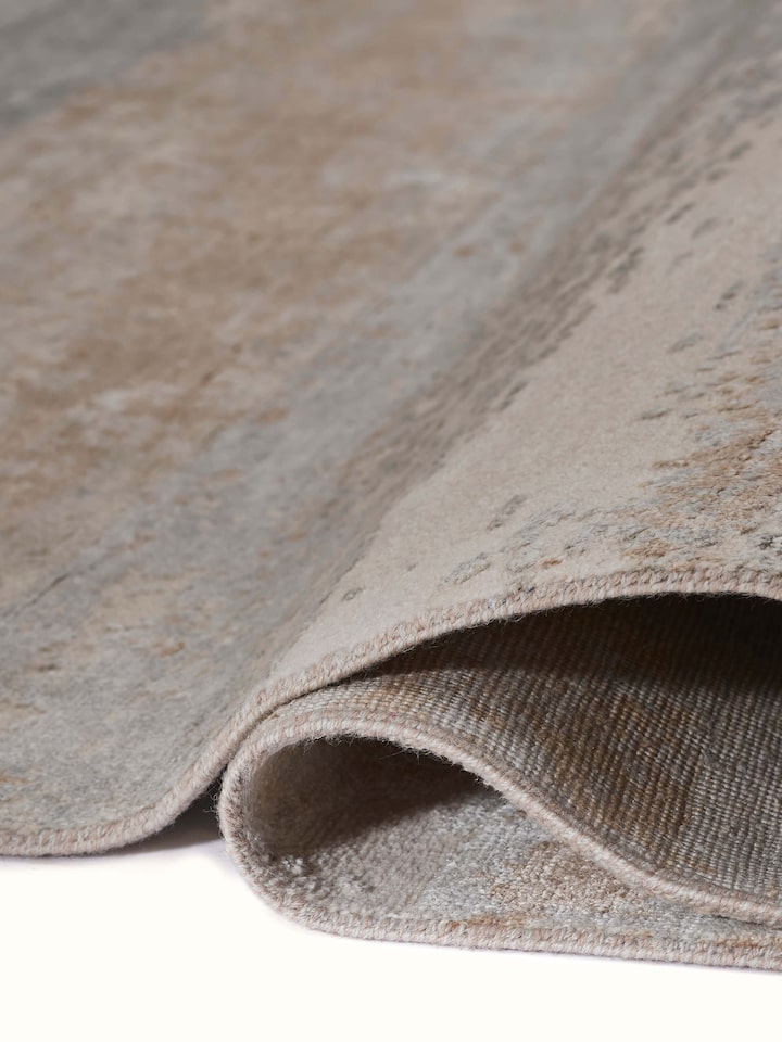 Side view of grey beige Agra hand-knotted carpet showcasing artistic texture