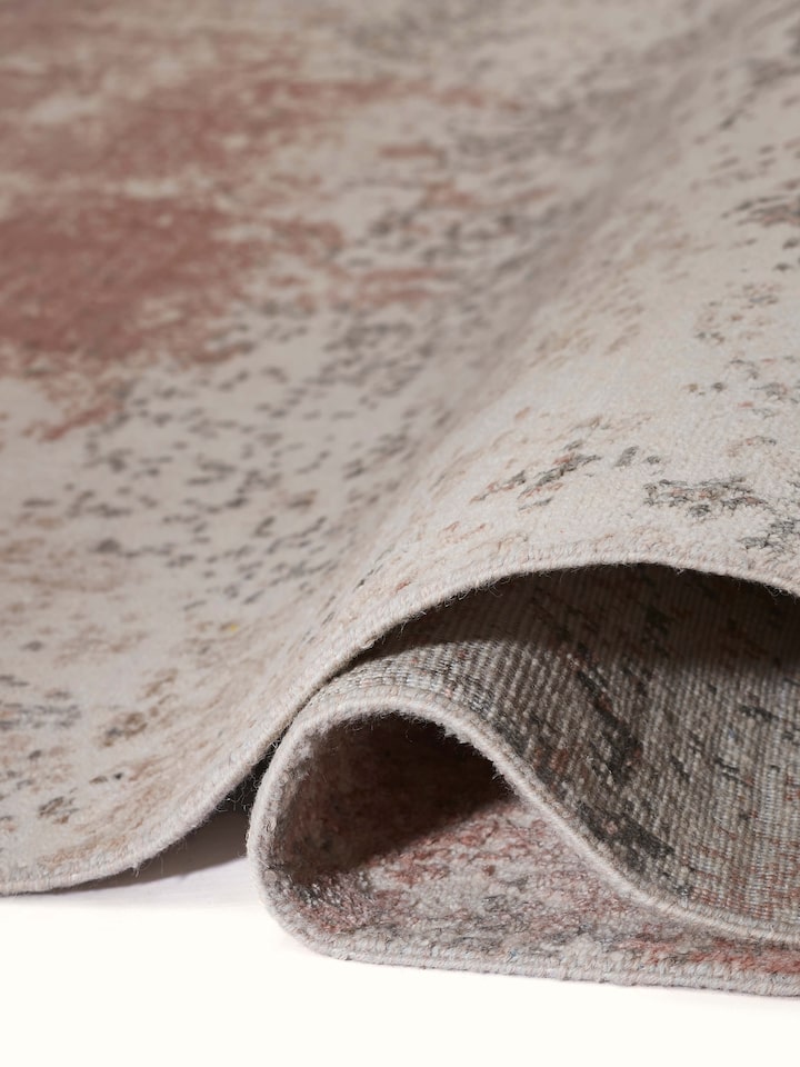 Close-up of modern abstract weave in peach and grey on Agra hand-knotted carpet.
