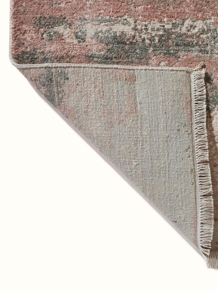 Back view of hand-knotted carpet revealing quality and fine weave texture.
