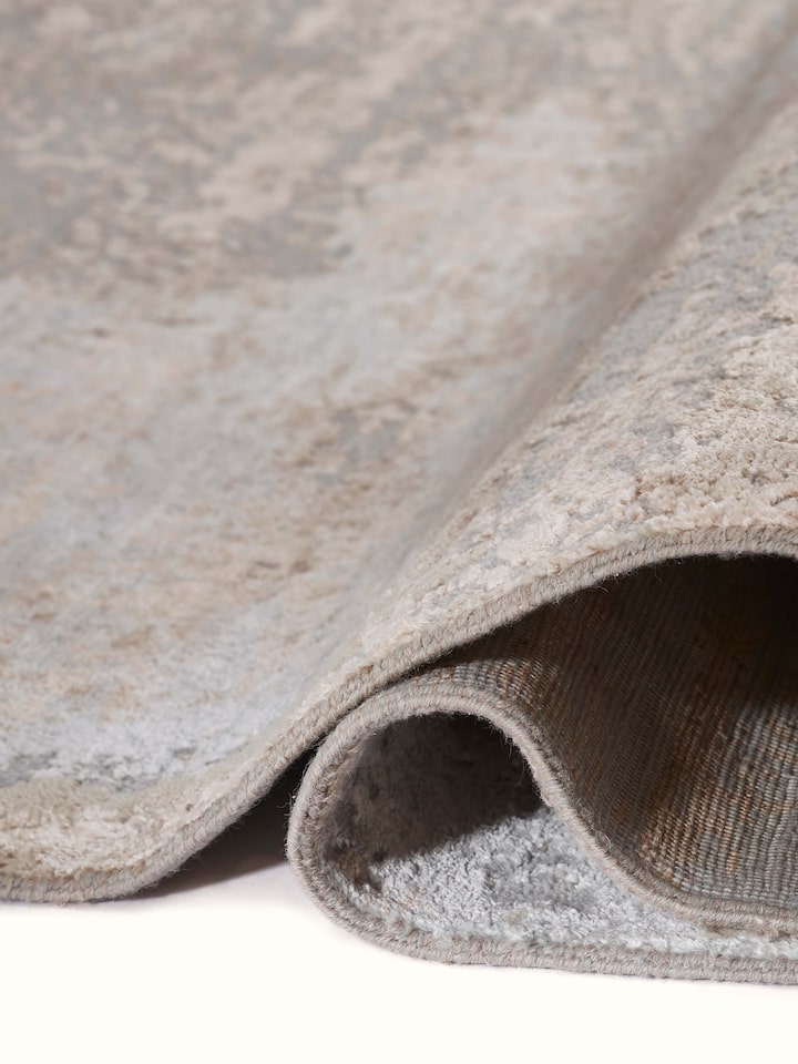 Detailed shot of Abstract modern grey blush wool & viscose hand-knotted carpet showing craftsmanship and weave