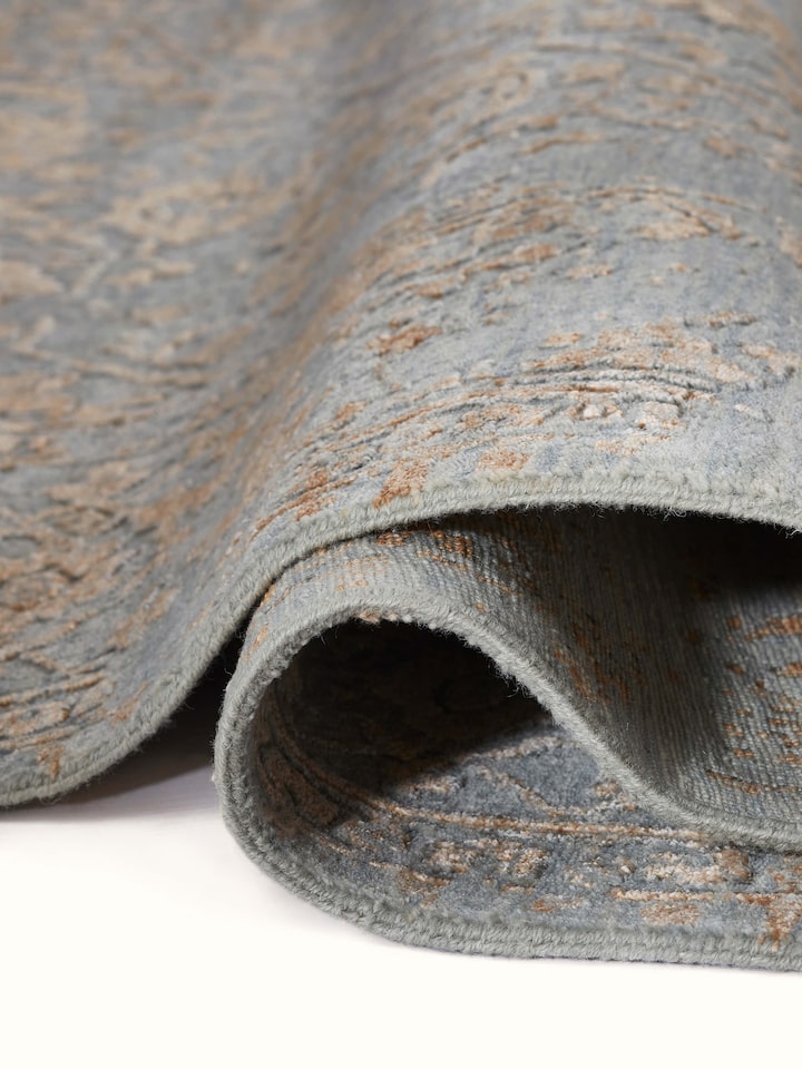 Detail view of Distressed Transitional Grey Copper Agra Wool & Viscose Hand-knotted Carpet highlighting the intricate pattern and pile texture, fro...