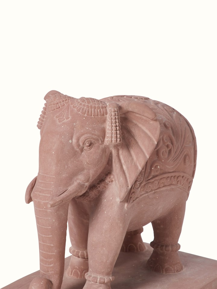 Angled view of Hastin carved stone Gwalior elephant sculpture, highlighting the craftsmanship and stone texture.