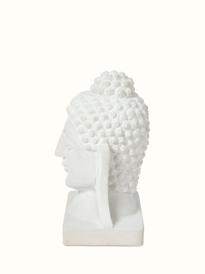 Detailed view of Tranquil Carved Stone Buddha Face Idol focusing on the texture and carving
