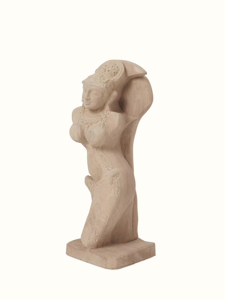 Side view of Graceful carved stone shilabalika sculpture highlighting the detailed carvings and artistic design