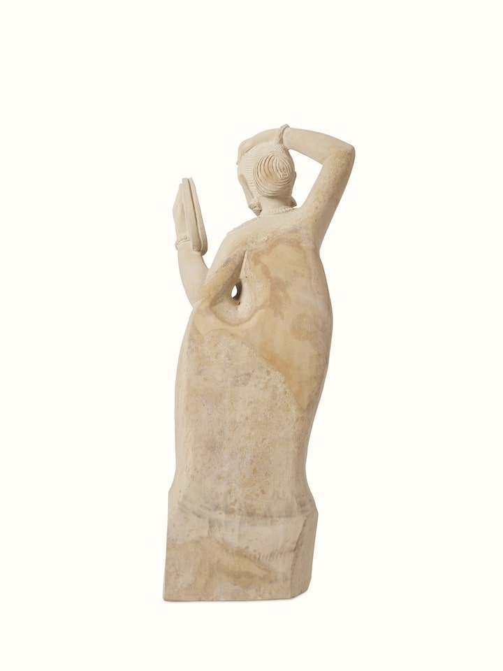 Back view of the Gwalior carved stone Apsara sculpture with a mirror.