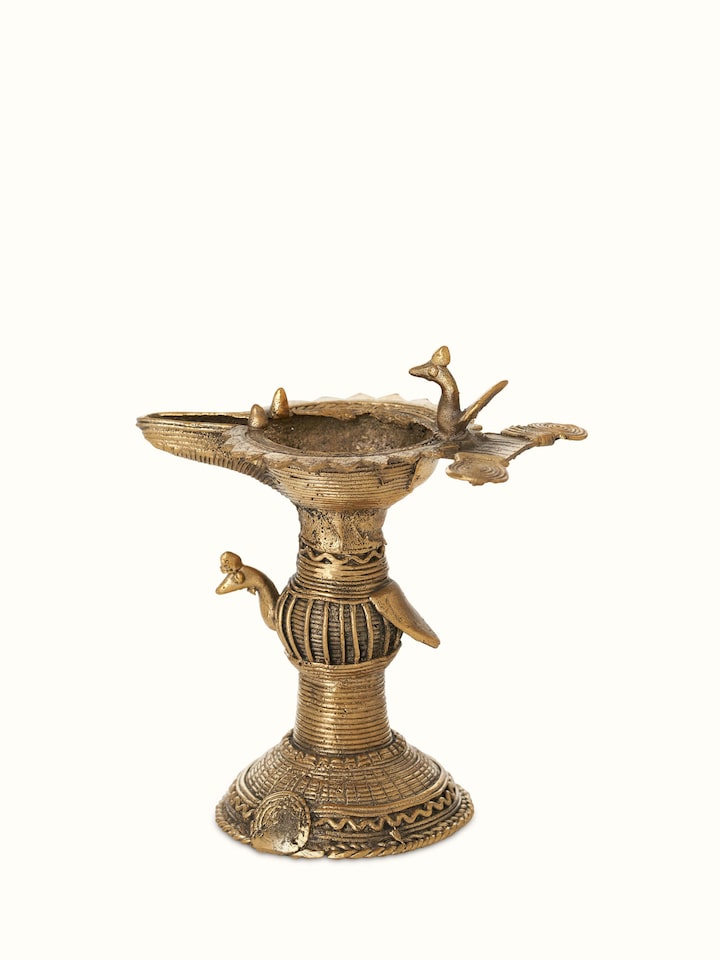 Detailed close-up of Antique brass dhokra diya emphasizing fine craftsmanship and design elements