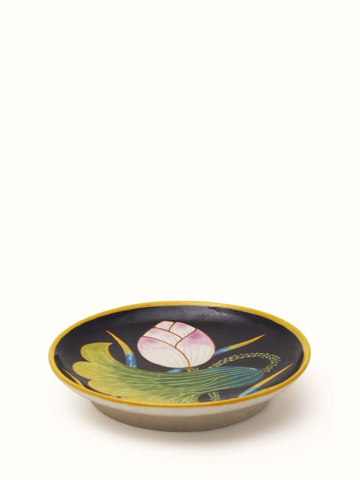 Side view of Blue pottery black flower display plate showcasing the detailed flower patterns and elegant design