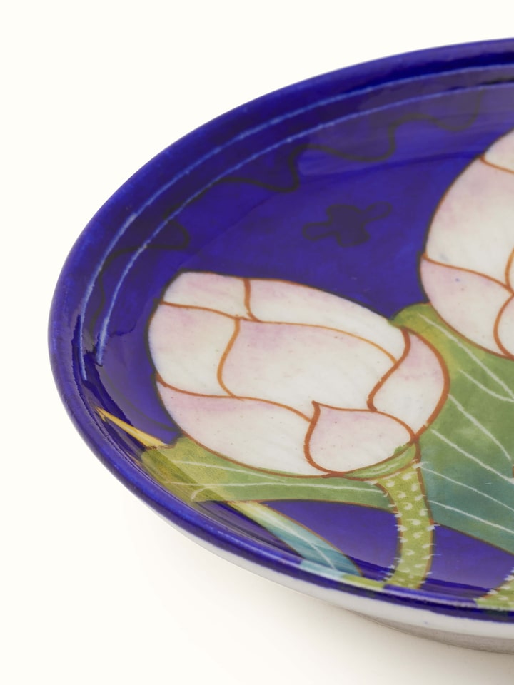 Back view of Blue Pottery Three Flowers Display Plate from Swadesh, highlighting the ceramic texture and vibrant flower designs.