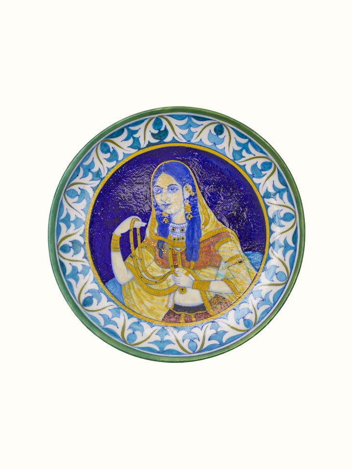 Close-up of Blue Pottery Mughal Woman Display Plate highlighting the intricate design and vivid blue pottery craftsmanship
