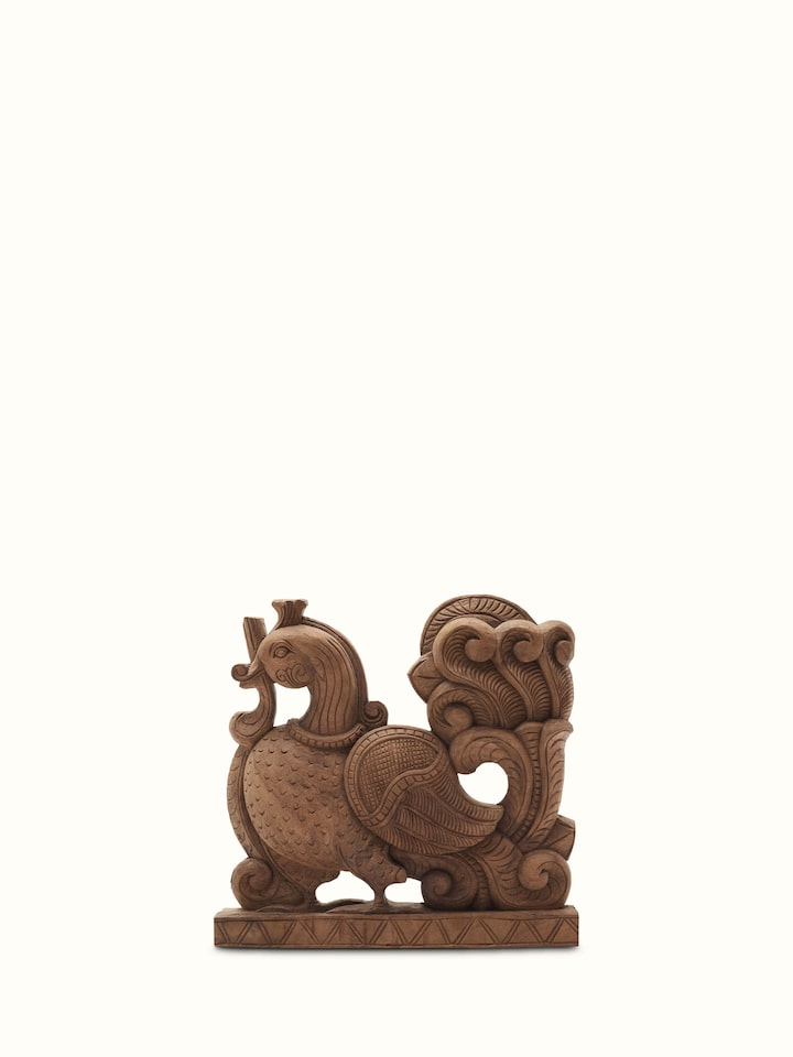 Close-up view of carved neem wood parrot brackets sculpture featuring fine craftsmanship.