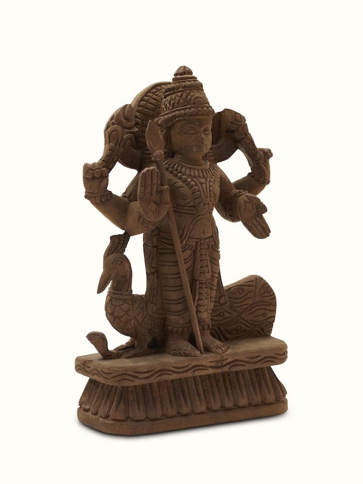 Side view of Karthikeya carved neem wood swamy idol highlighting the fine woodwork and elegant detailing