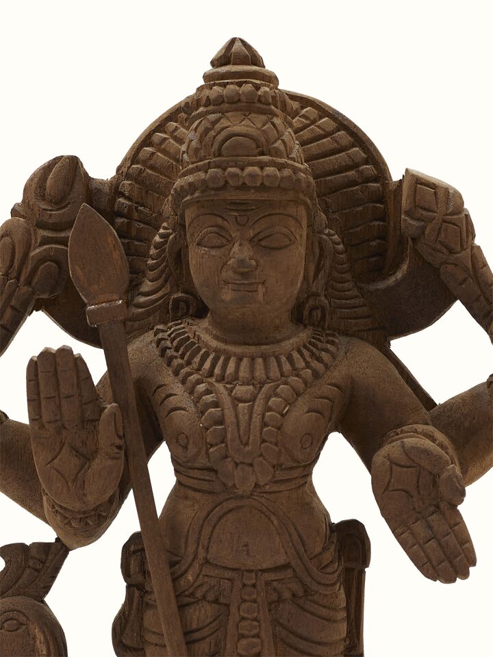 Close-up of Karthikeya carved neem wood swamy idol showing detailed craftsmanship and natural wood texture