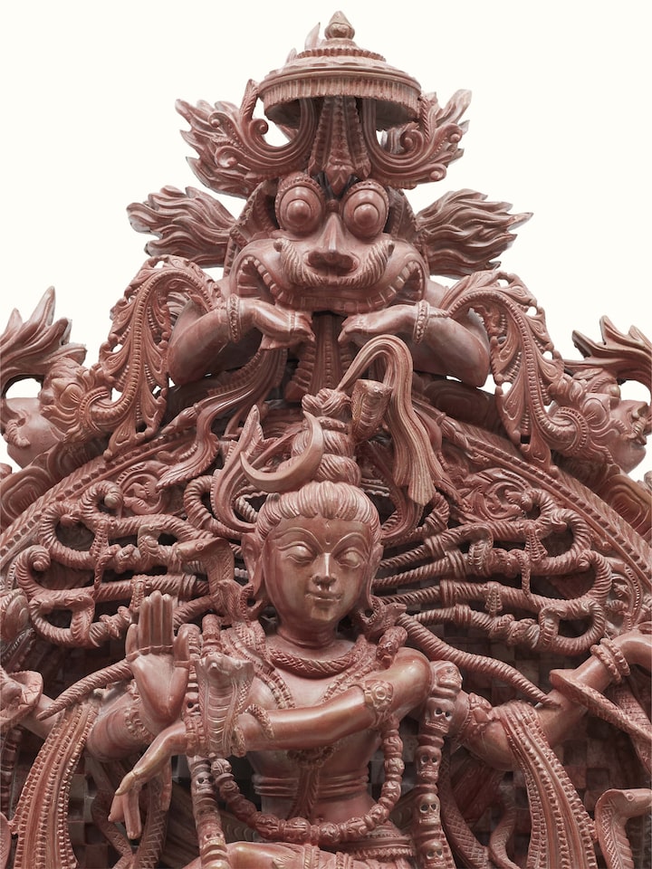 Artistic view of Carved stone Natraj idol in tandav dance, highlighting the stone texture and dance movement.